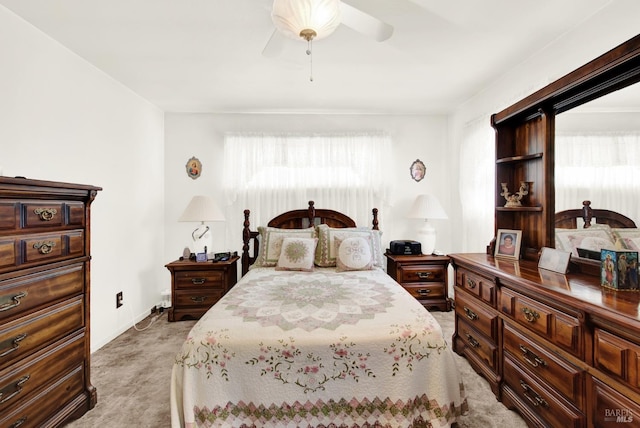 bedroom with light carpet and a ceiling fan