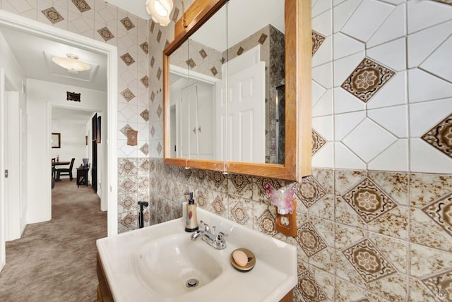 bathroom with backsplash, a sink, and tile walls