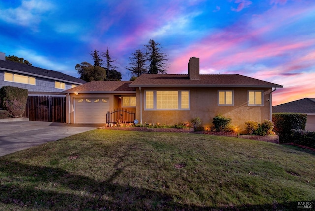 single story home with a garage, driveway, a lawn, a chimney, and stucco siding