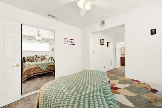 bedroom featuring carpet floors, visible vents, and ceiling fan