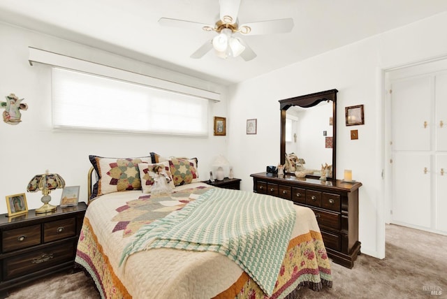 bedroom with light carpet and a ceiling fan