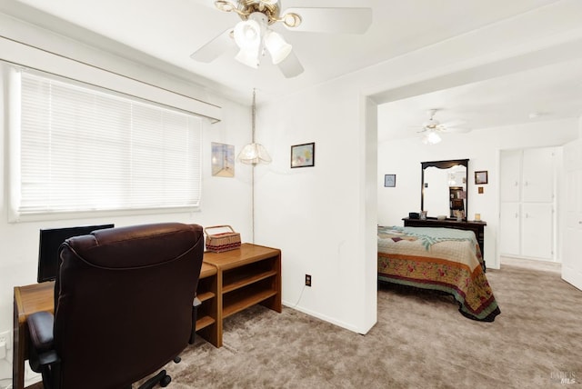 office space featuring ceiling fan, baseboards, and light colored carpet