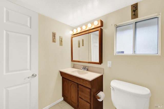 half bathroom with toilet, baseboards, and vanity