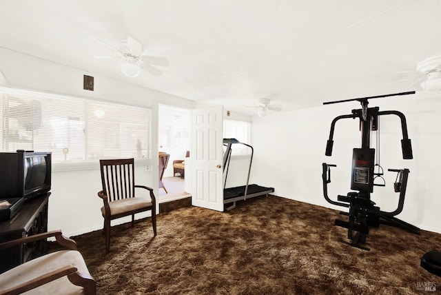 workout area featuring dark colored carpet and ceiling fan