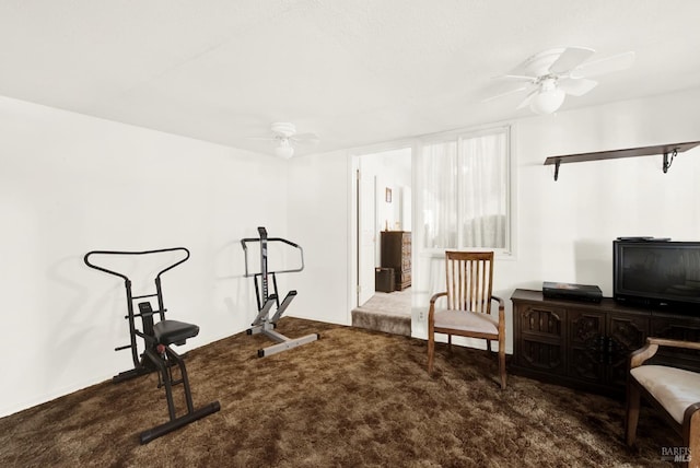 workout room with dark colored carpet and ceiling fan