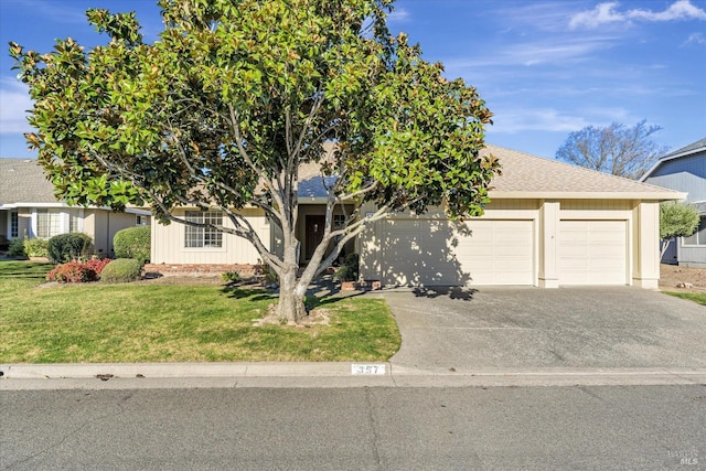 obstructed view of property with a front lawn and a garage