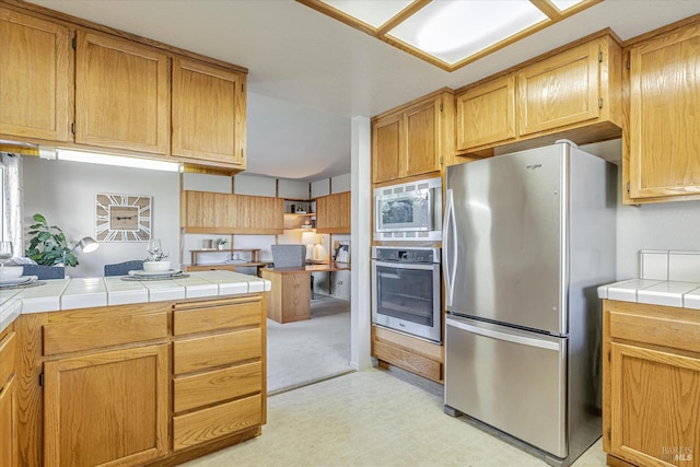 kitchen with stainless steel appliances and tile counters