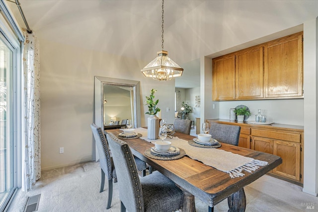 dining room with baseboards, visible vents, light carpet, and an inviting chandelier