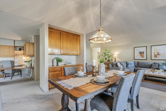 dining area featuring light carpet, an inviting chandelier, and vaulted ceiling