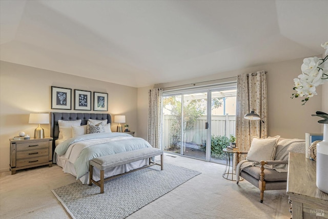 bedroom featuring access to exterior and light carpet