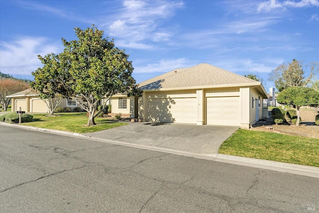 view of front of house with a garage and a front lawn