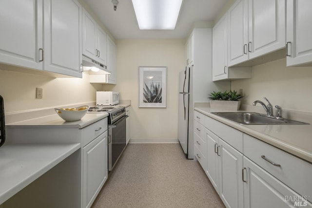 kitchen with sink, stainless steel electric range oven, refrigerator, and white cabinets