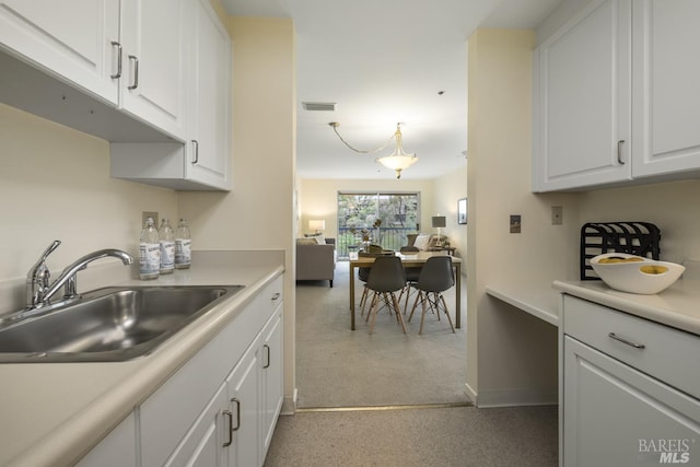 kitchen featuring sink and white cabinetry