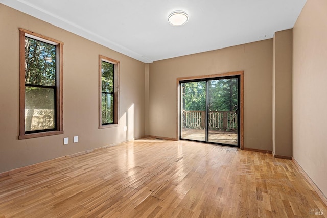 unfurnished room with light hardwood / wood-style floors