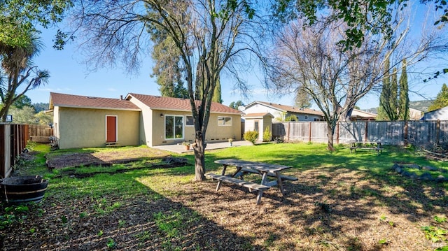 rear view of property with a patio and a yard