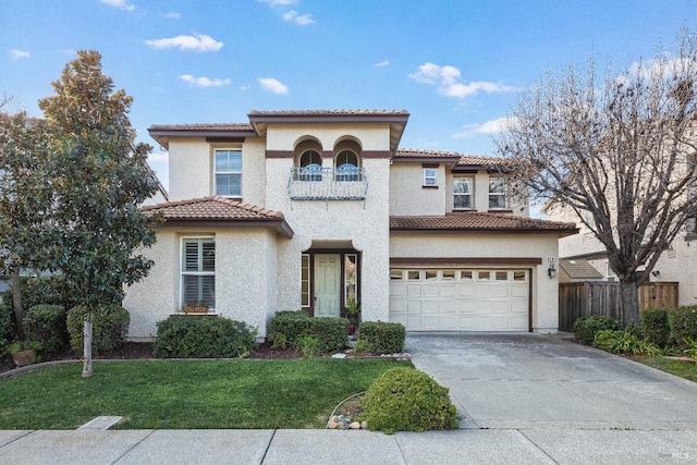 mediterranean / spanish home featuring a garage and a front lawn