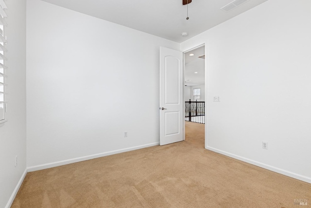 carpeted empty room with ceiling fan