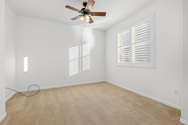 spare room featuring light carpet and ceiling fan