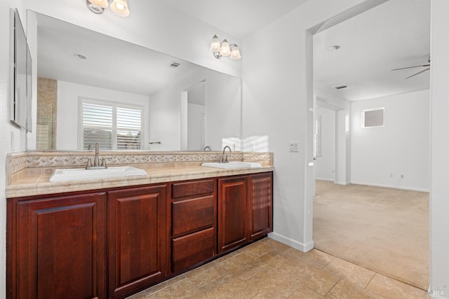 bathroom with ceiling fan and vanity