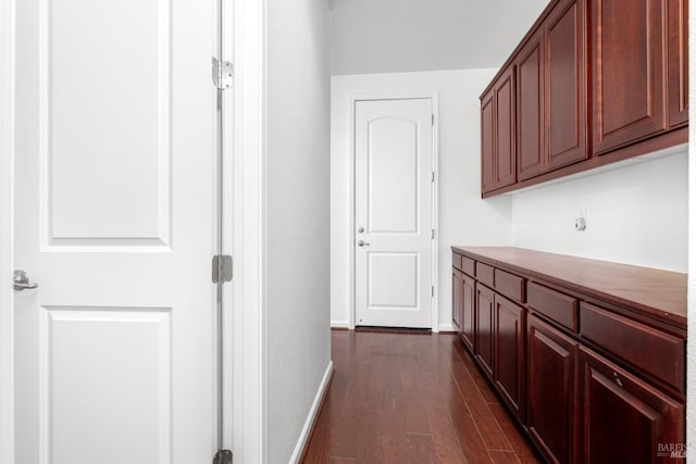 corridor featuring dark hardwood / wood-style floors