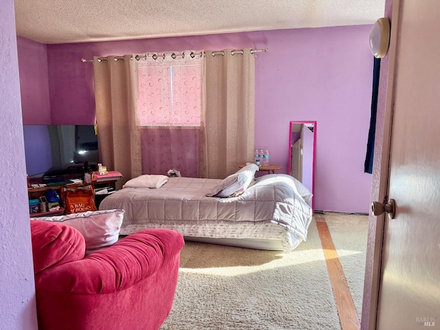 bedroom with a textured ceiling and carpet floors