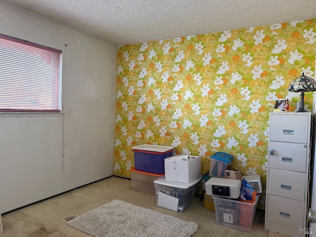 empty room featuring a textured ceiling and wallpapered walls