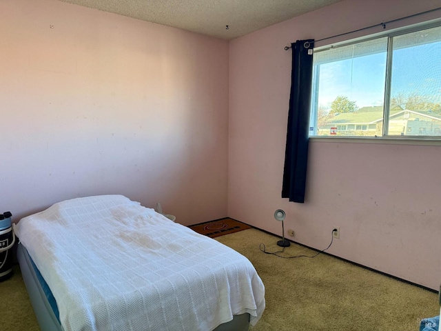 carpeted bedroom featuring a textured ceiling