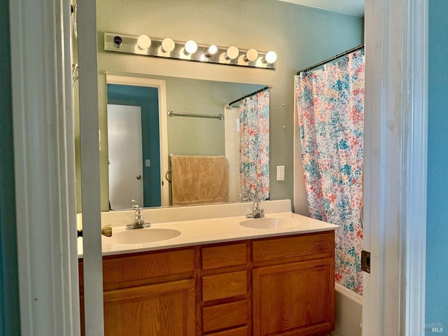 full bath featuring double vanity, shower / bath combination with curtain, and a sink