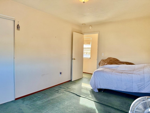 bedroom featuring carpet floors and baseboards