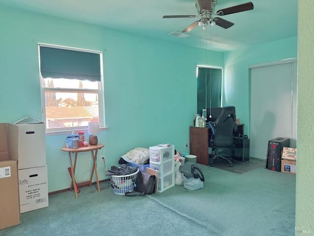 interior space with ceiling fan and visible vents