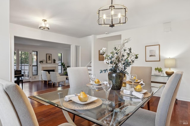 dining room with a notable chandelier and dark wood-type flooring