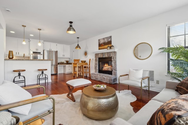 living room with a fireplace and dark hardwood / wood-style floors