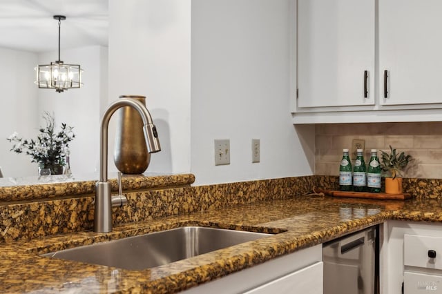 kitchen featuring sink, decorative light fixtures, white cabinetry, dishwasher, and backsplash