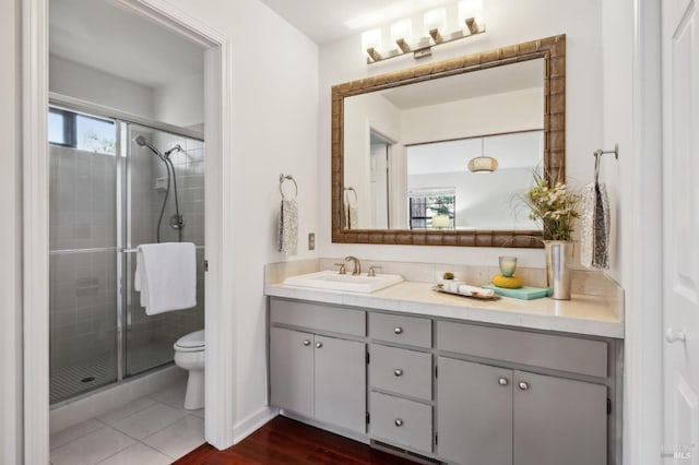 bathroom with walk in shower, tile patterned flooring, vanity, and toilet