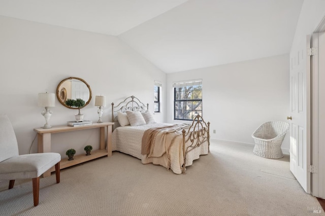 bedroom featuring vaulted ceiling and carpet