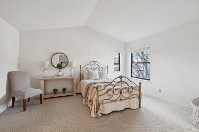 bedroom featuring light colored carpet and vaulted ceiling