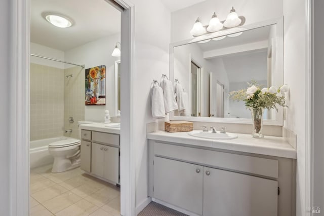 full bathroom with vanity, tiled shower / bath, tile patterned floors, and toilet