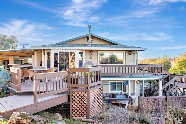 rear view of property with stairway and a wooden deck