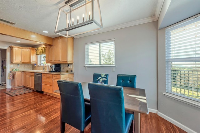 dining room with dark wood finished floors, visible vents, ornamental molding, a textured ceiling, and baseboards