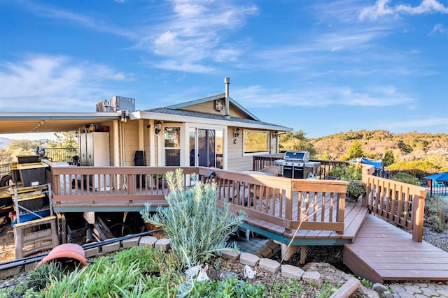 rear view of house featuring a deck with mountain view