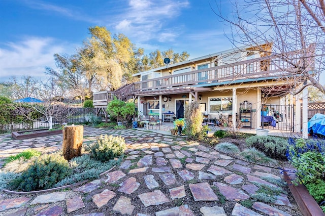 back of house with a patio, fence, and a wooden deck