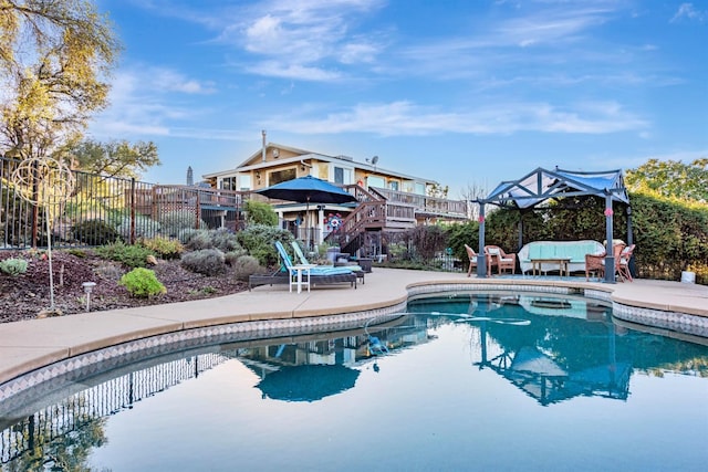 pool with a patio area, stairway, fence, and an outdoor hangout area