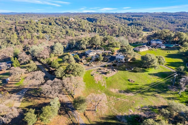 bird's eye view featuring a wooded view