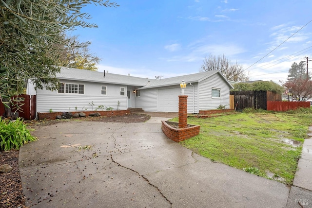 ranch-style home with a garage and a front lawn