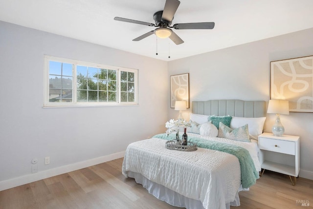 bedroom with ceiling fan and light hardwood / wood-style floors