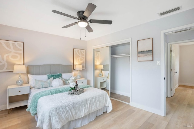 bedroom with ceiling fan, a closet, and light hardwood / wood-style floors