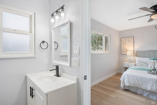 bathroom with ceiling fan, wood-type flooring, and vanity