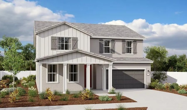 view of front of property featuring fence, concrete driveway, a garage, a tile roof, and board and batten siding