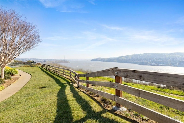 view of yard with a water and mountain view and a rural view