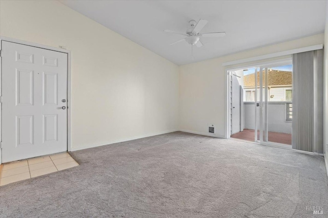 empty room featuring lofted ceiling, ceiling fan, and light carpet